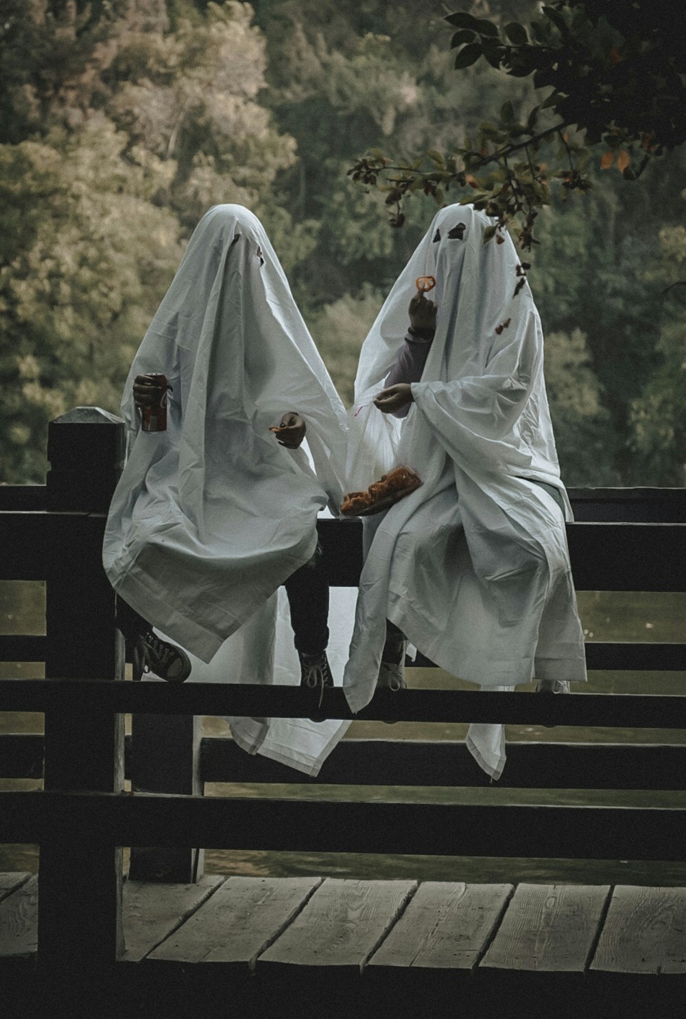 person in white hijab sitting on brown wooden bench