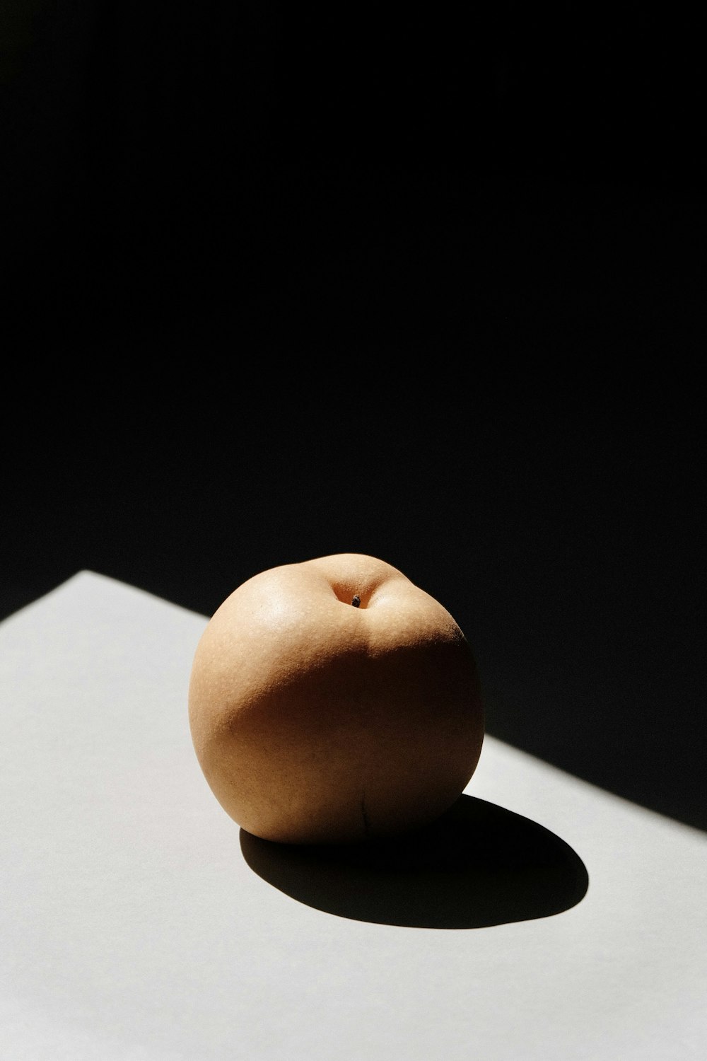 brown apple fruit on white table