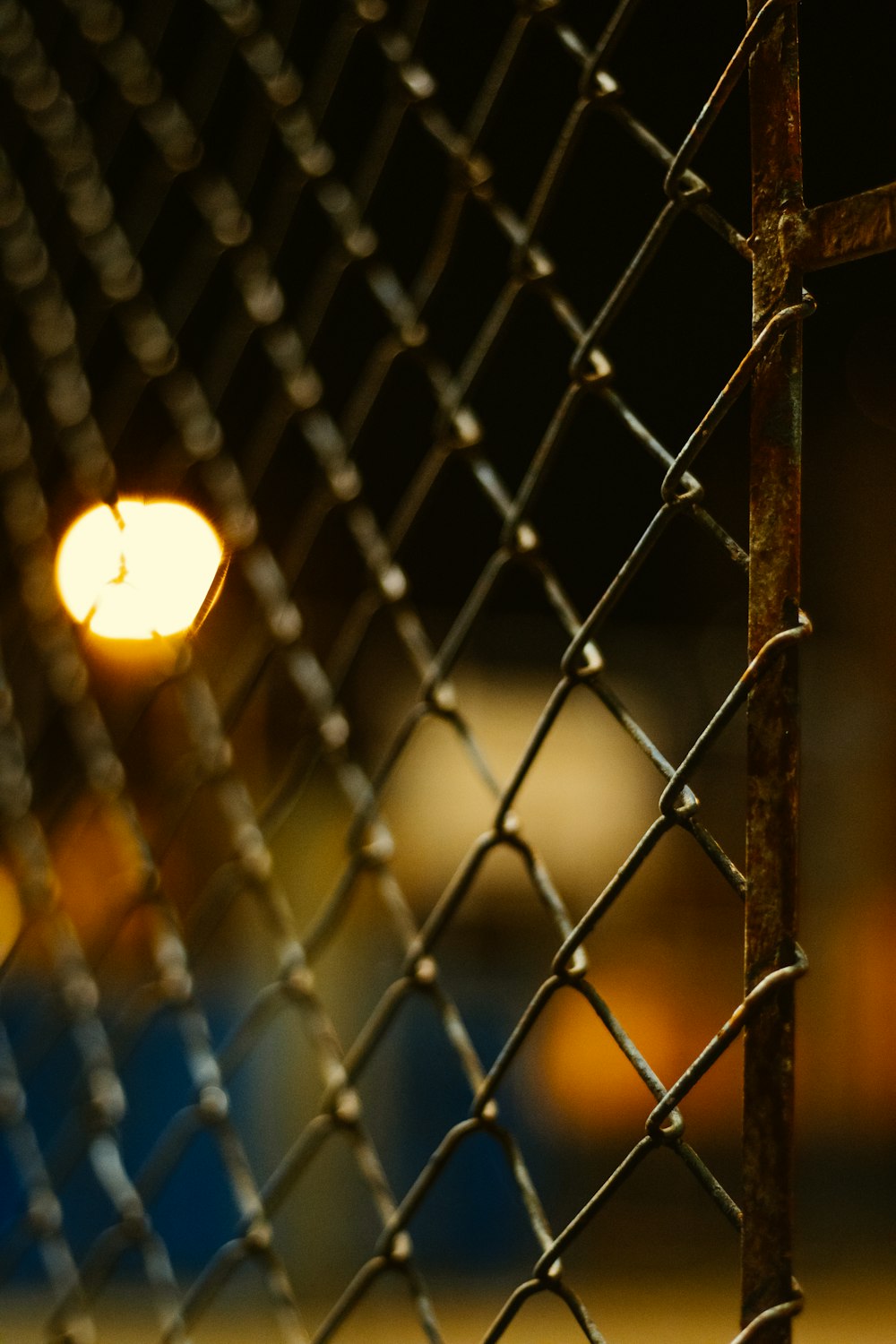 grey metal fence during night time