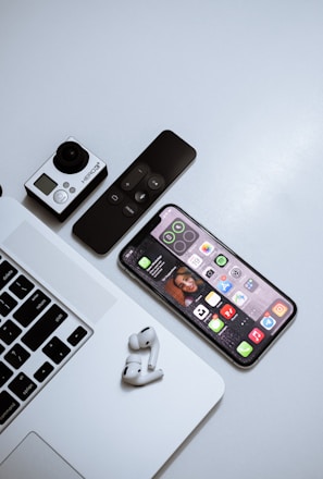 black iphone 4 beside white apple wireless keyboard and white wireless mouse