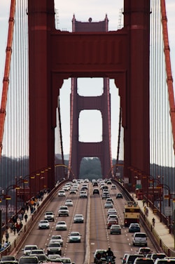 red bridge over body of water during daytime