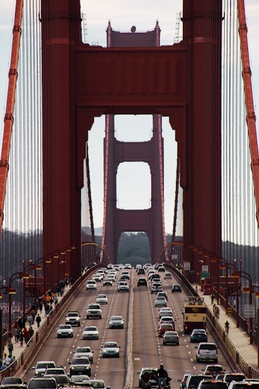 red bridge over body of water during daytime