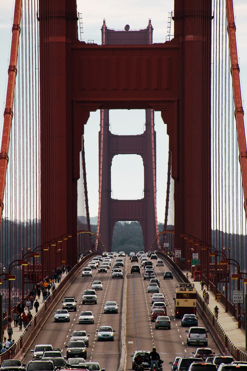 red bridge over body of water during daytime