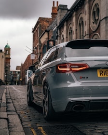 silver car parked on sidewalk during daytime