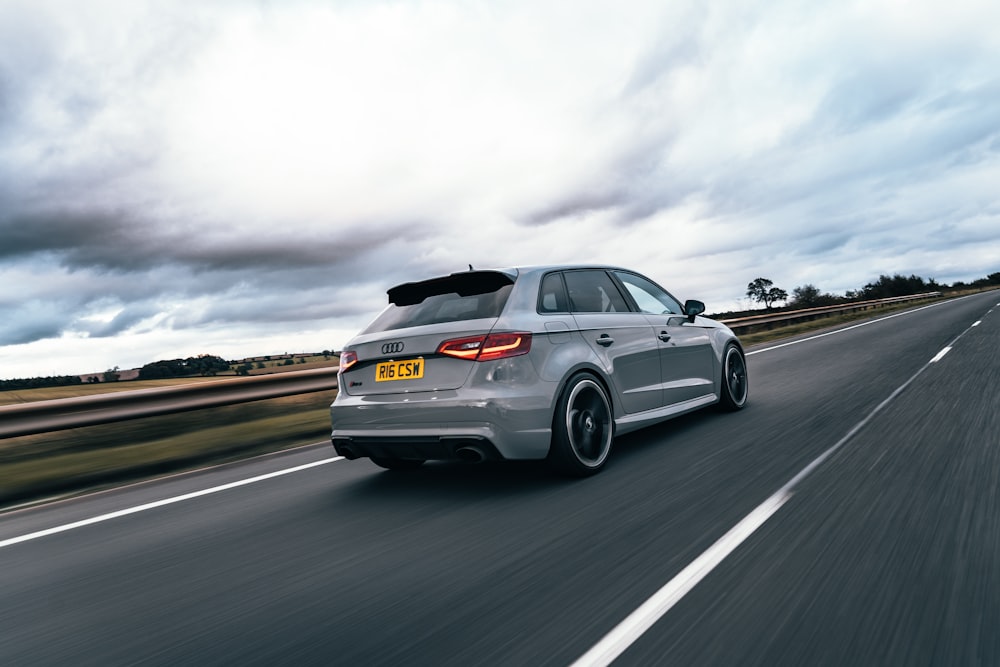 silver sedan on gray asphalt road during daytime