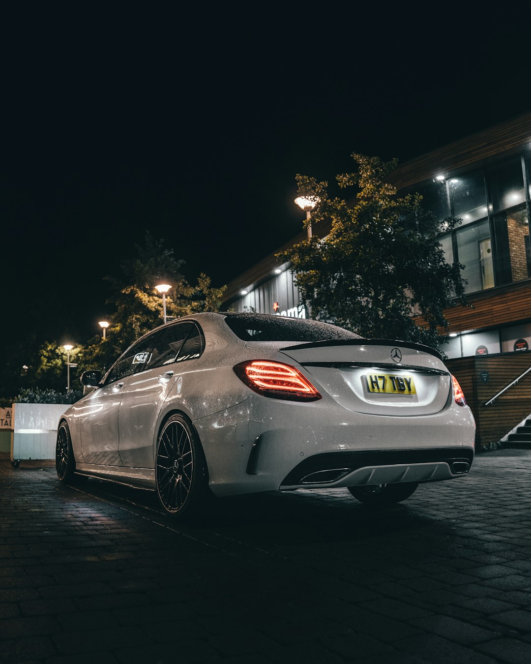 silver bmw m 3 coupe parked on gray concrete pavement during night time