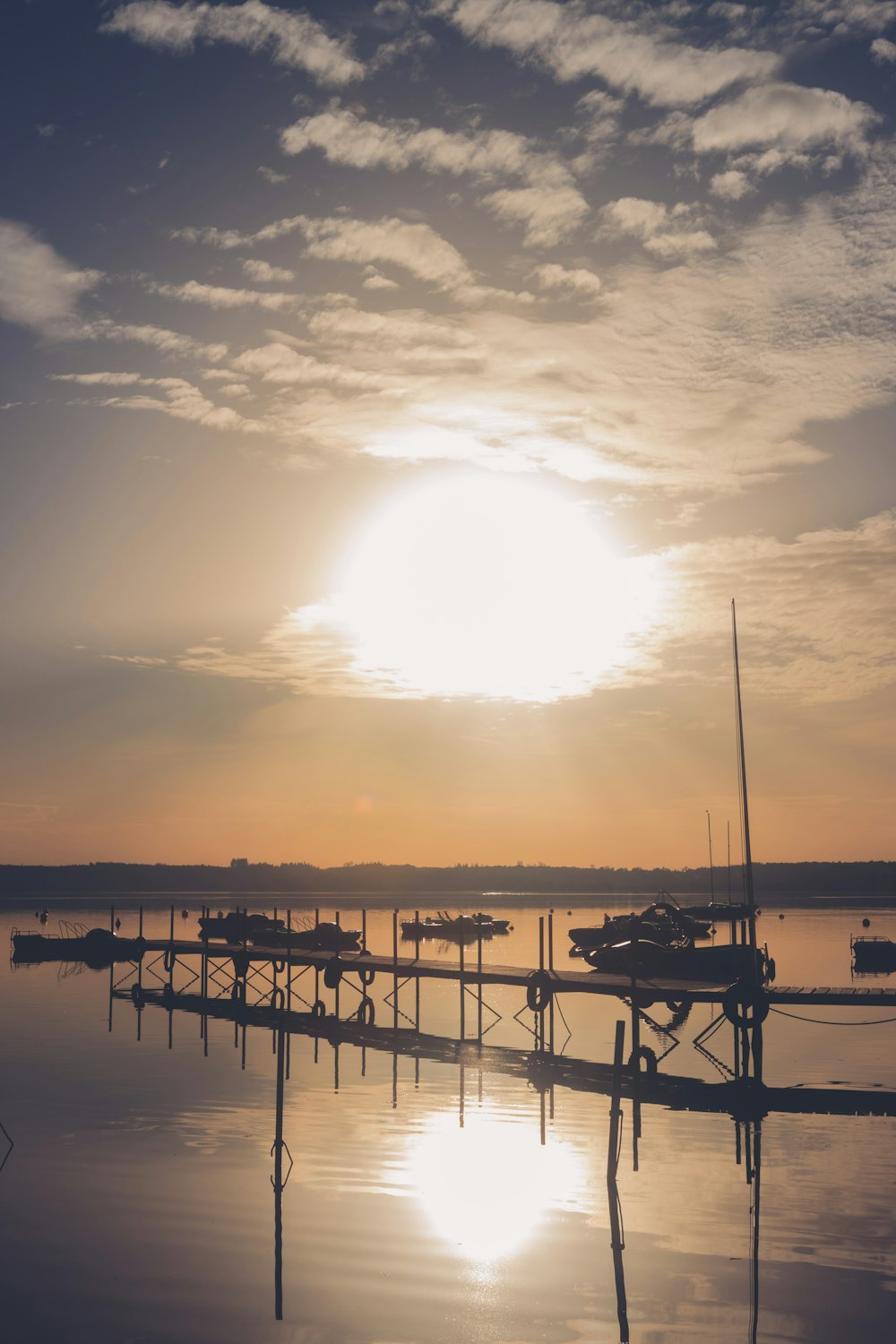 silhouette of people on dock during sunset