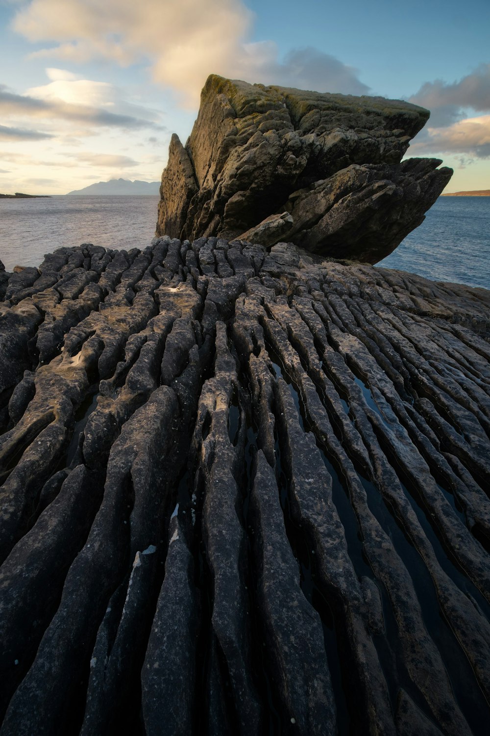 brown rock formation near body of water during daytime