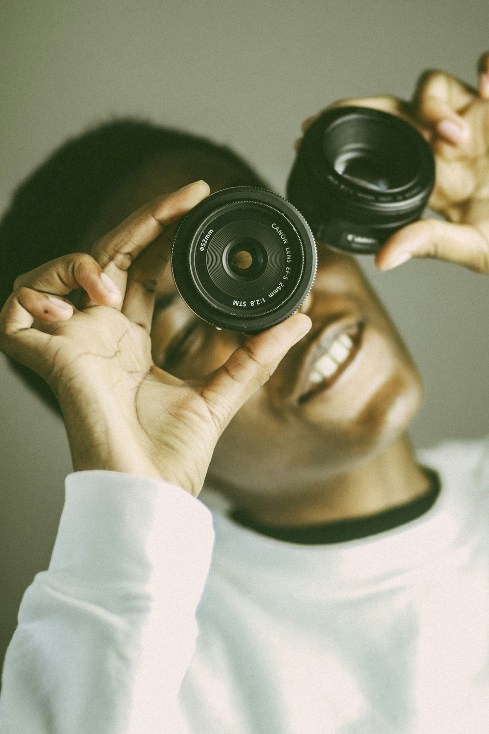 person holding black camera lens