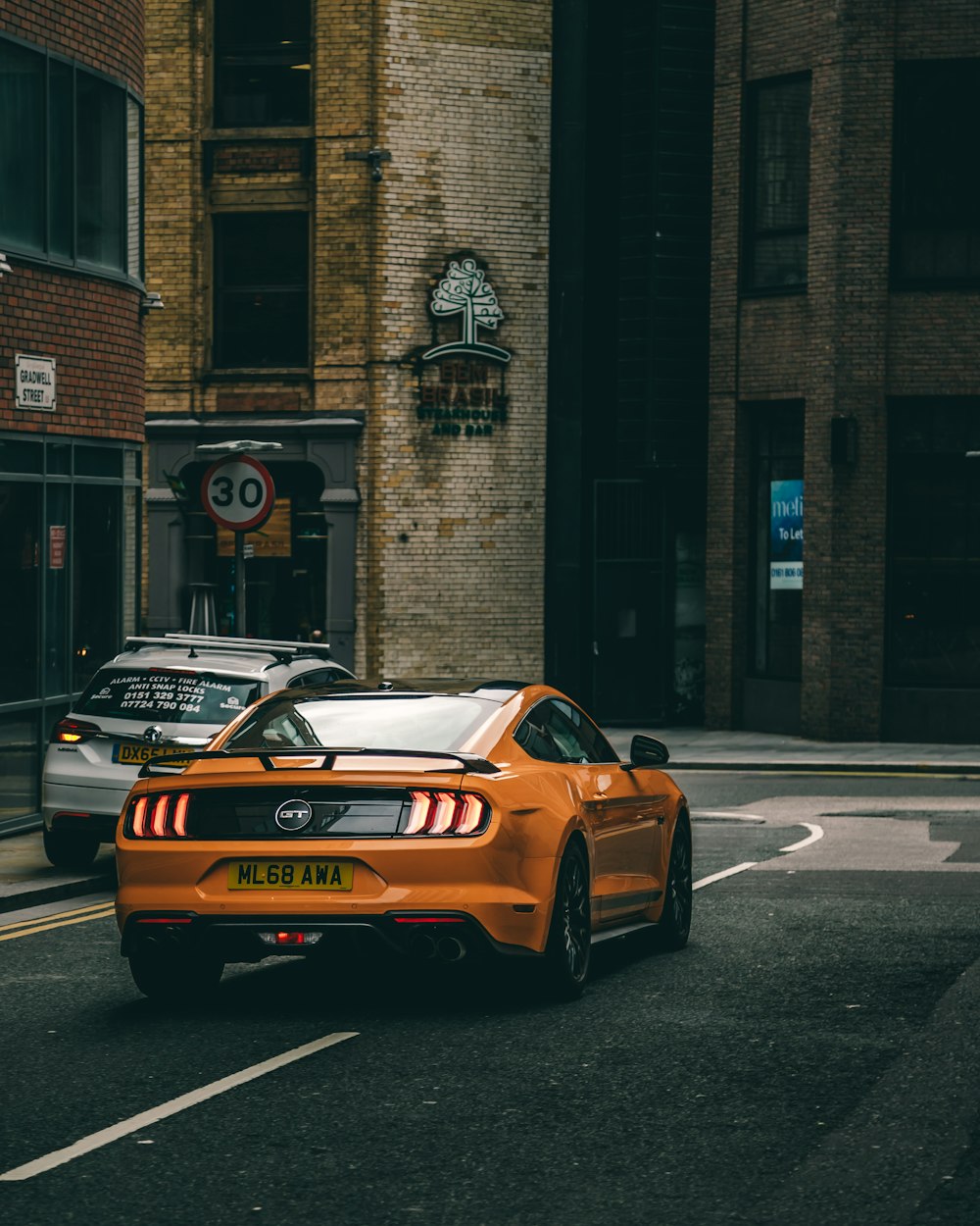 yellow porsche 911 on road during daytime