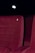 A red upholstered theater seat is prominently featured with the number three embossed on its backrest. The background is dimly lit, suggesting a cinema or theater environment.