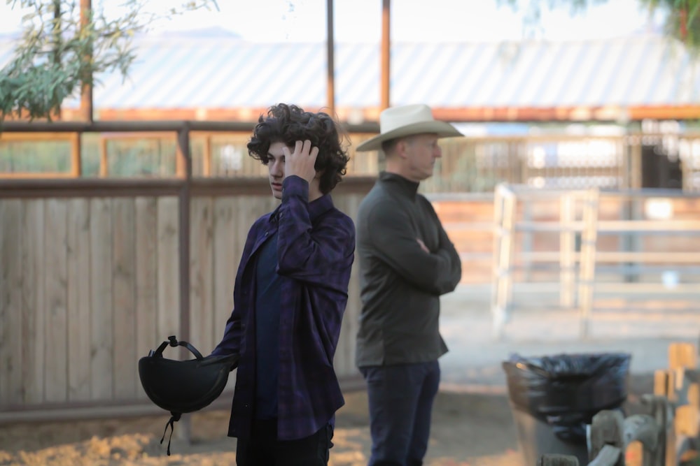 man in black coat standing beside woman in black coat