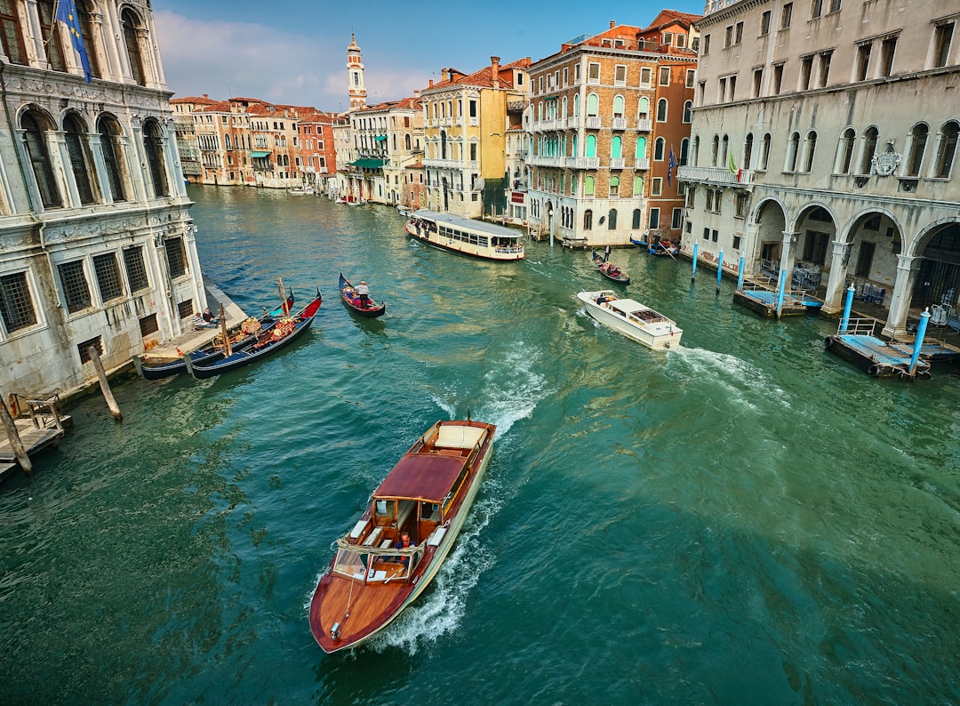 brown boat on river near buildings during daytime