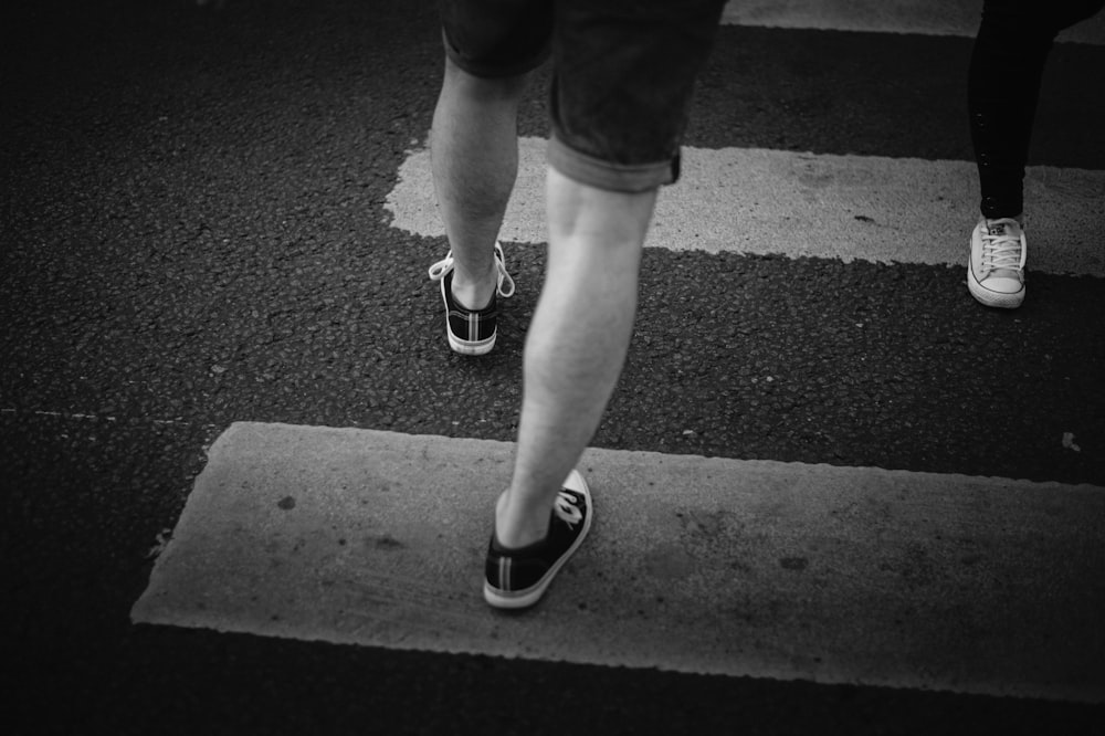 person in black shorts and black and white nike sneakers