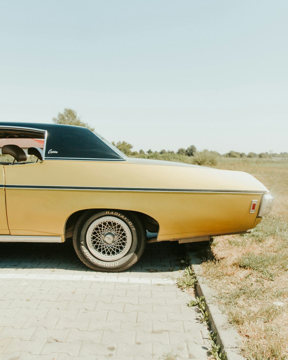 beige chevrolet camaro on road during daytime