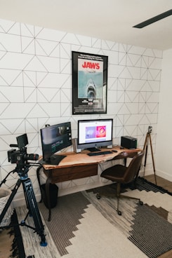 black flat screen computer monitor on brown wooden desk
