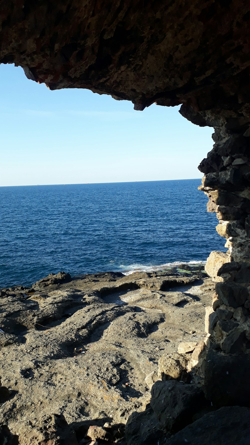 brown rock formation near body of water during daytime