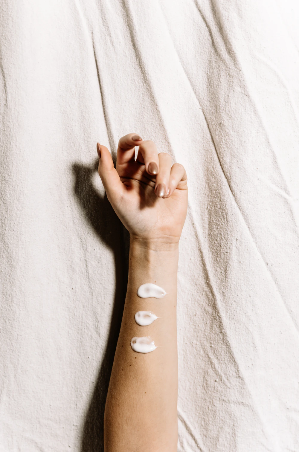 Dabs of white aftercare cream on skin