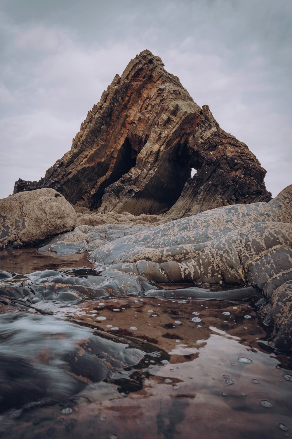 brown rock formation on water