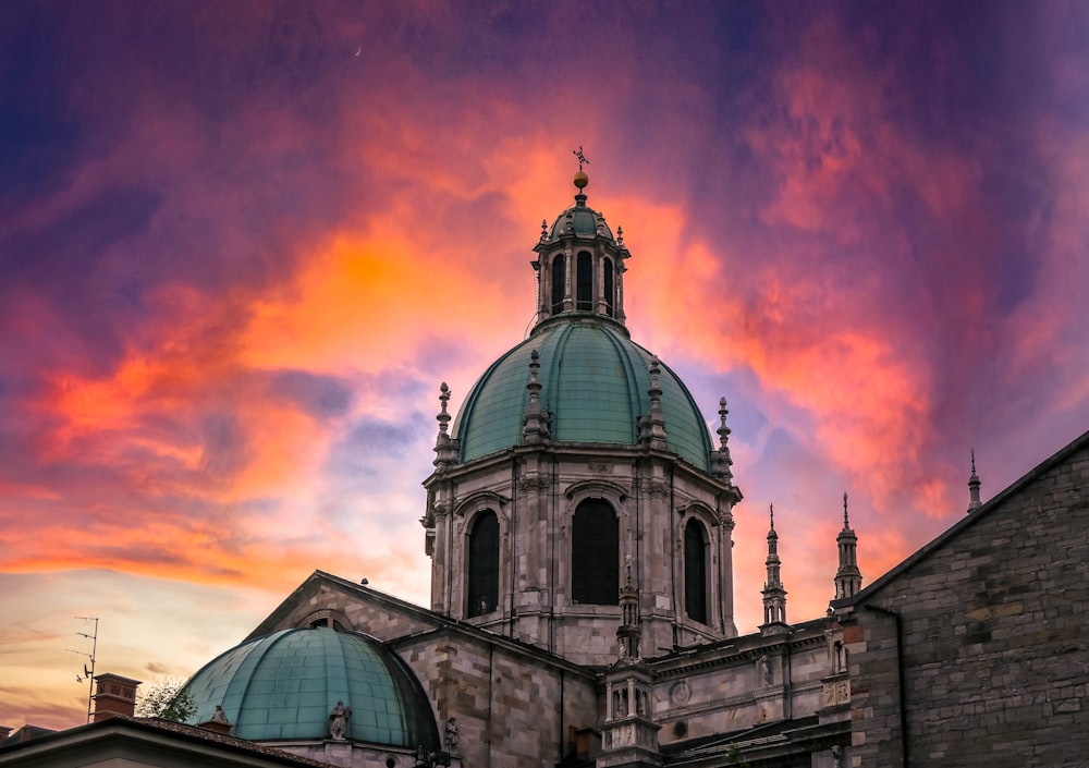 blue and white dome building under orange and blue sky