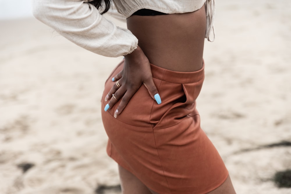 woman in white long sleeve shirt and orange skirt
