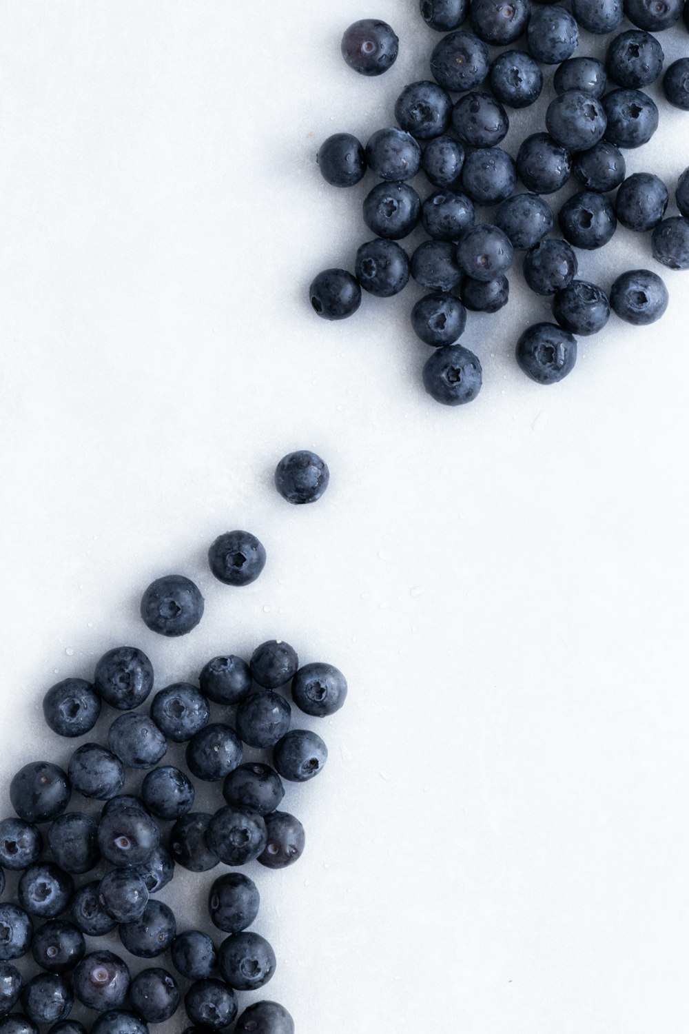 blue berries on white surface