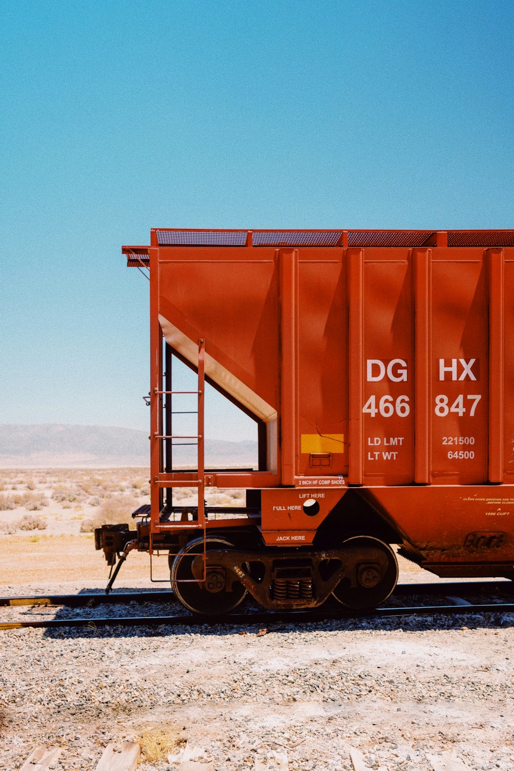 brown metal train on rail tracks during daytime