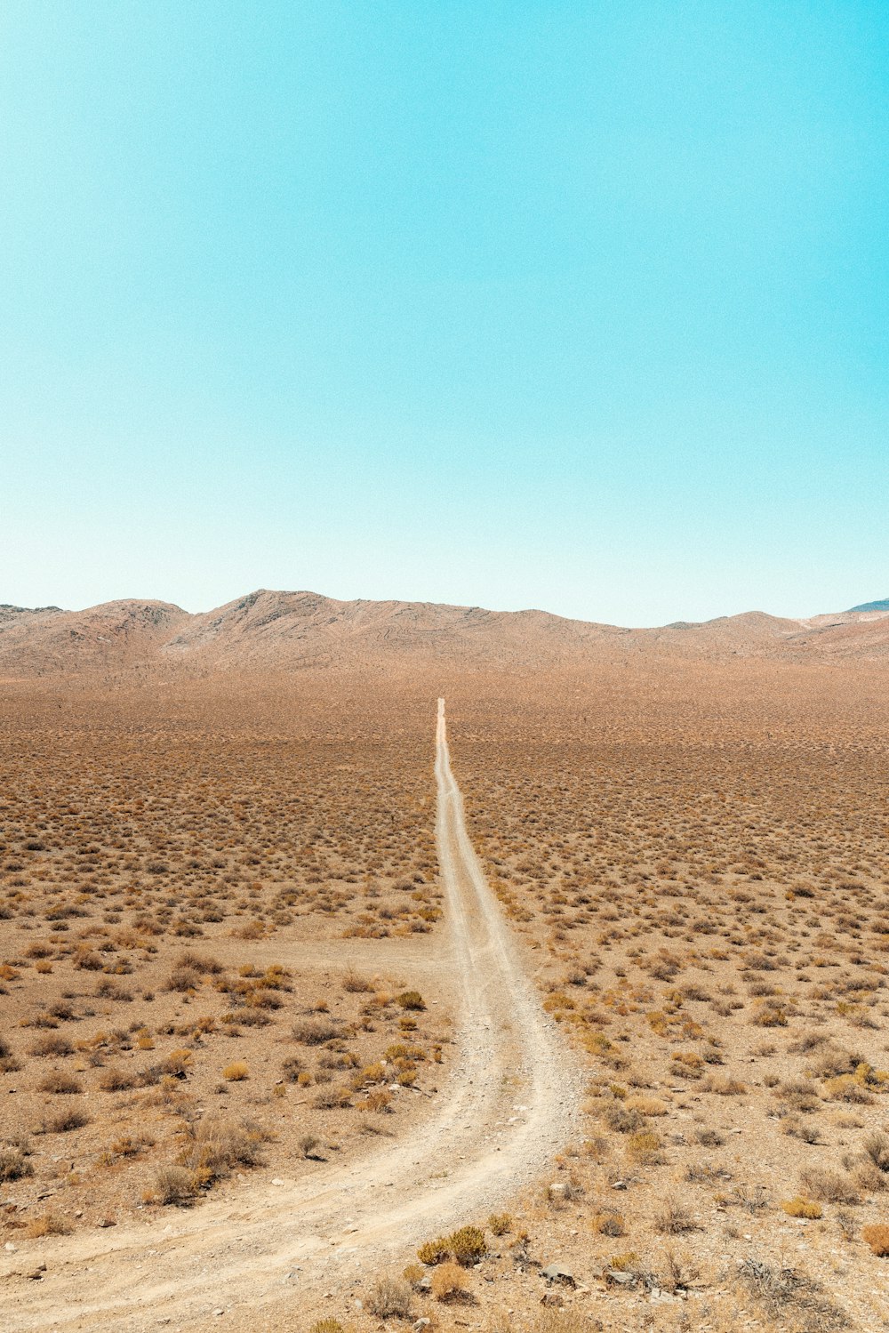 brown sand near brown mountain during daytime