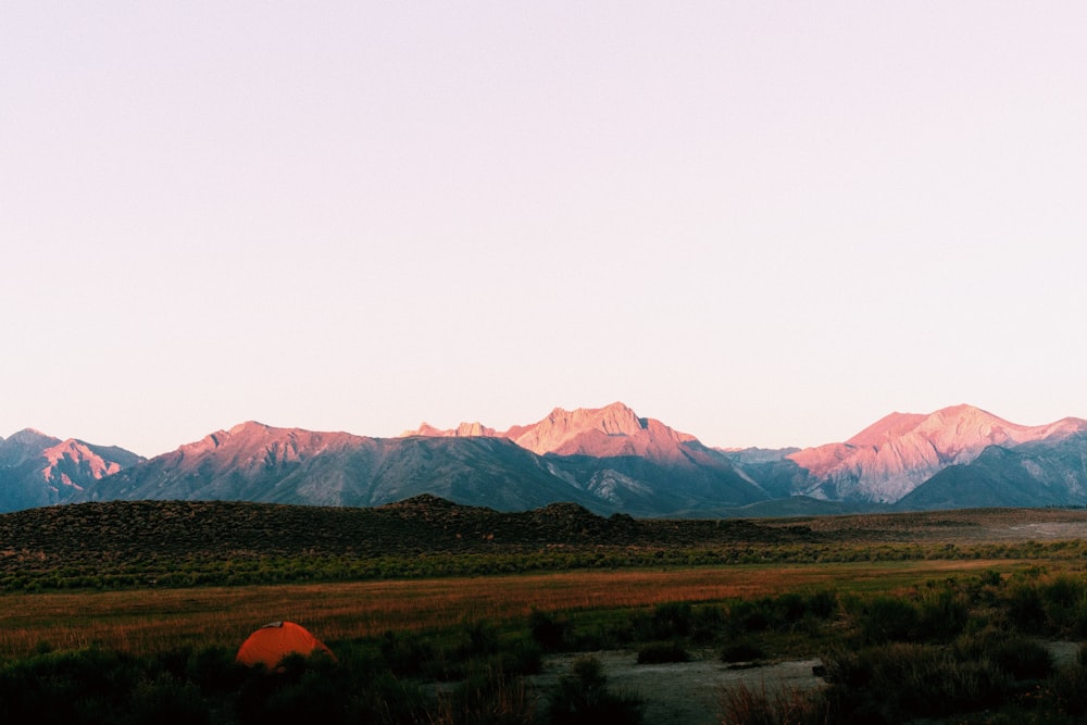 green grass field near mountains during daytime