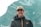 man in black jacket and brown cap