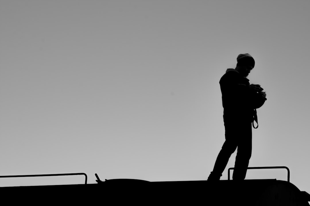 silhouette of man standing on the beach