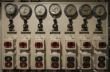 Close-up of a steam boiler control panel with gauges and valves