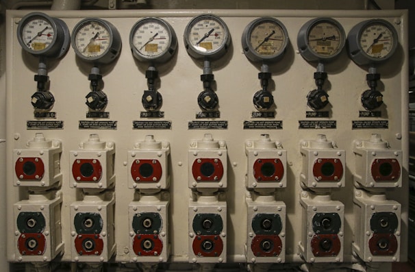 Close-up of a sophisticated laboratory gas distribution panel with multiple gauges and valves.