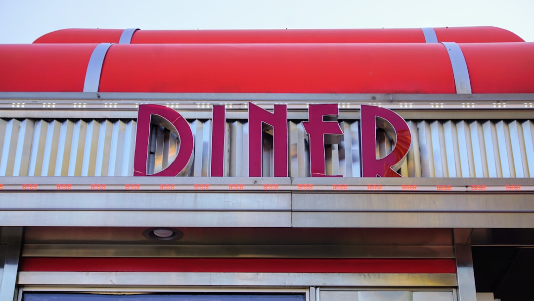 a sign that says diner on the side of a building,