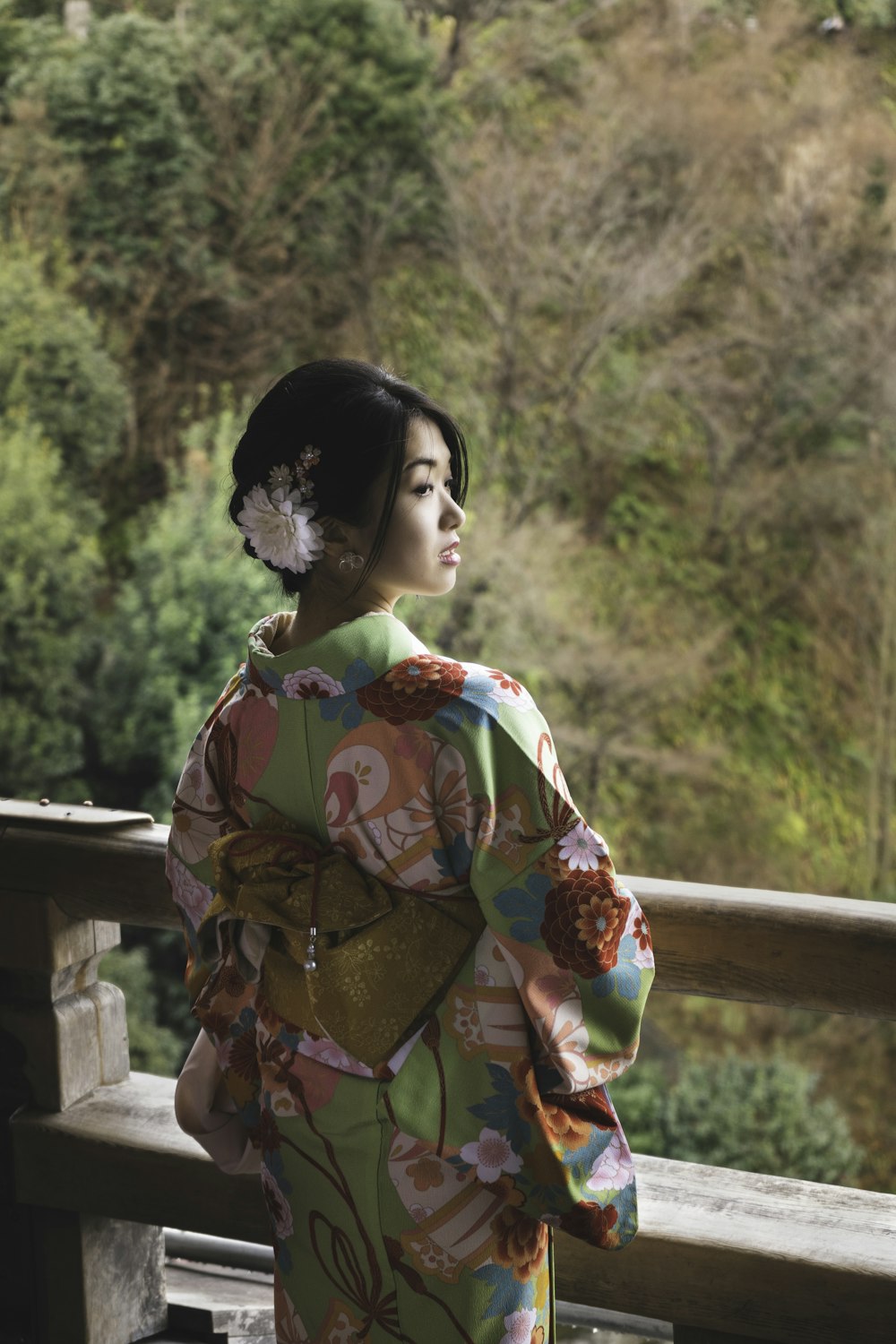 Woman in red and yellow floral kimono standing near brown wooden fence  during daytime photo – Free Kyoto Image on Unsplash
