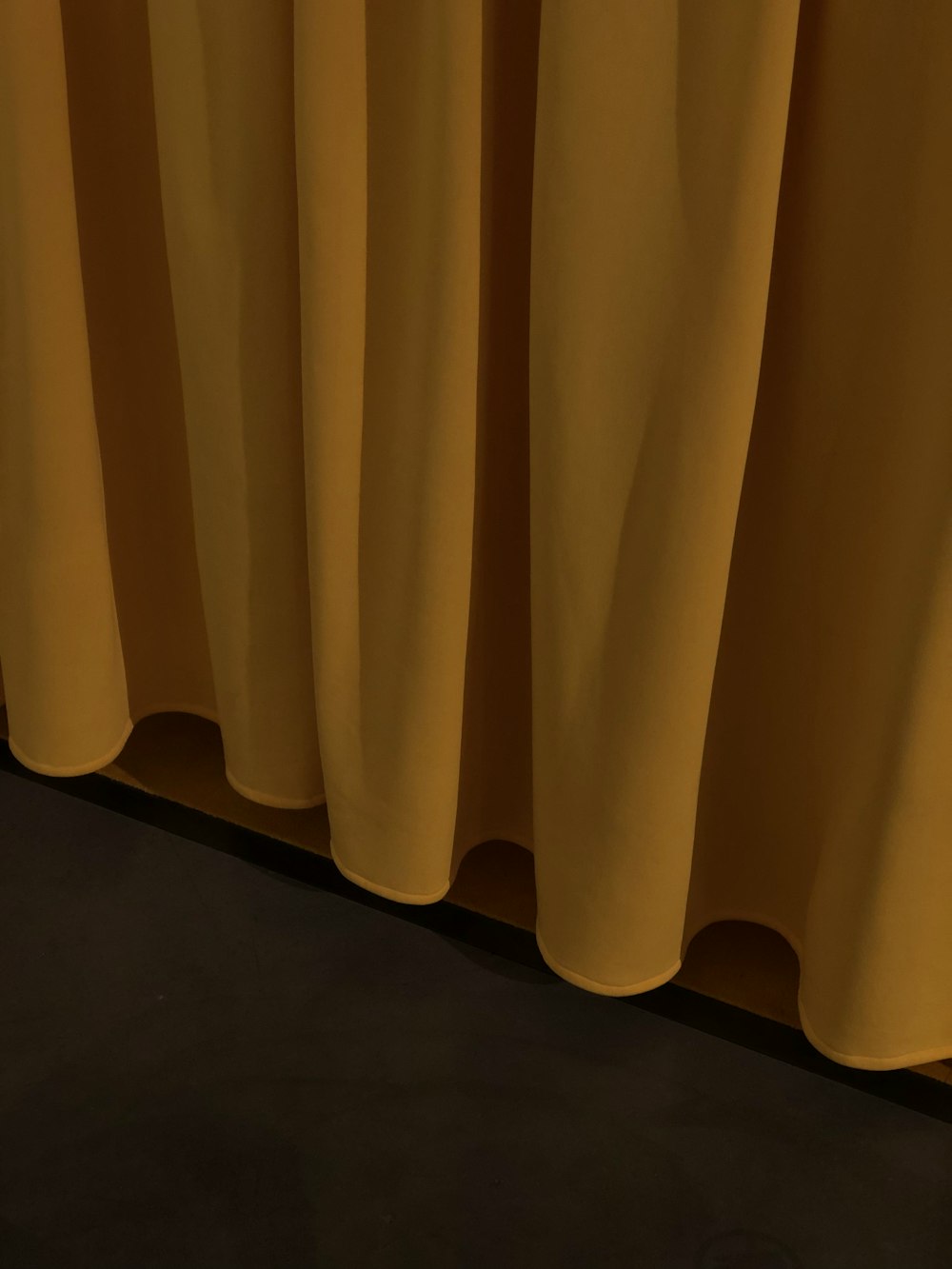 yellow curtain on brown wooden floor