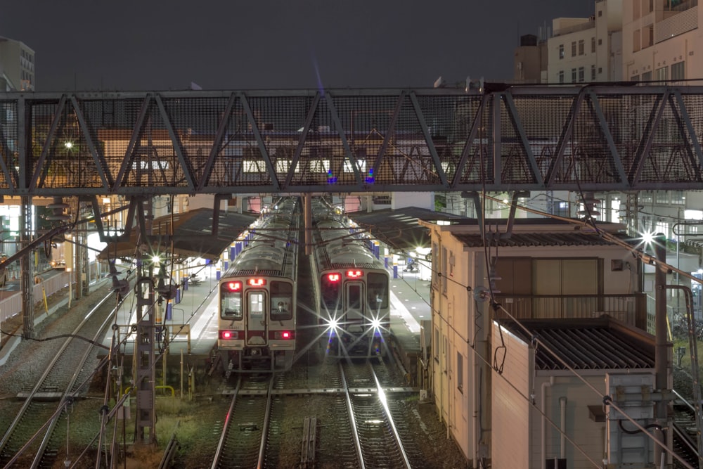 red and white train on rail tracks during night time