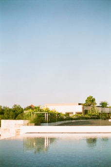 A serene residential villa with modern architecture set against a clear blue sky in Indore.