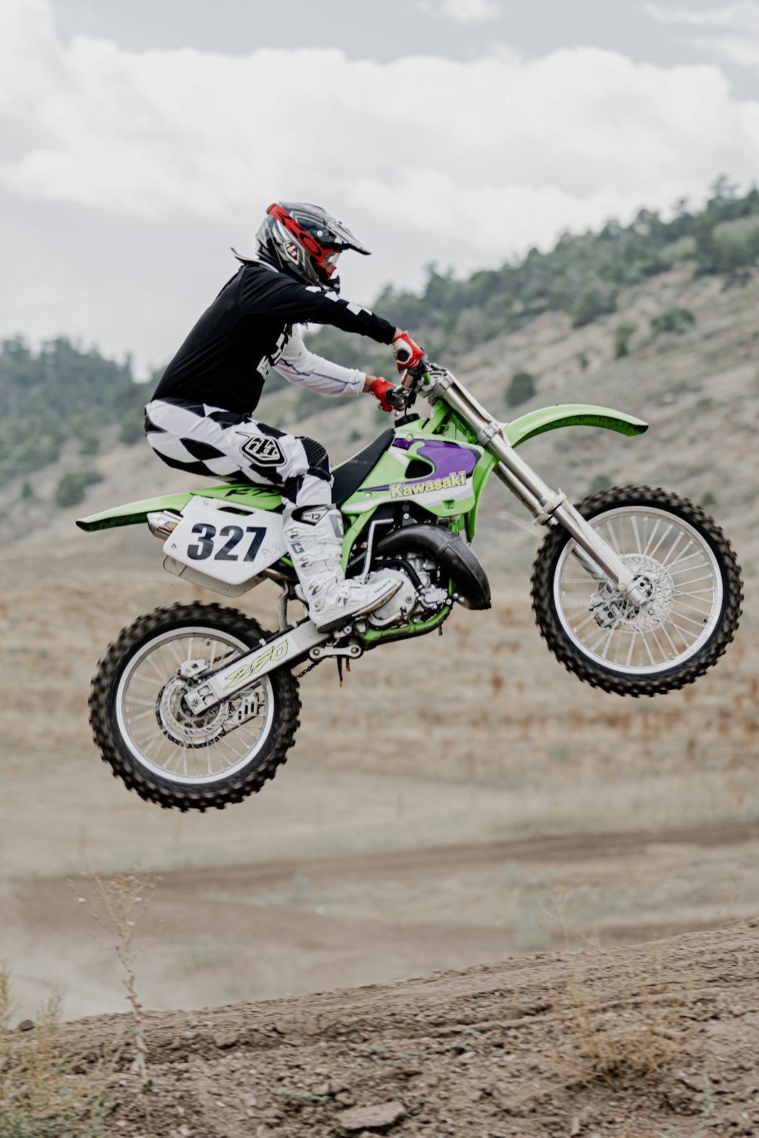 man in black and green motocross suit riding motocross dirt bike