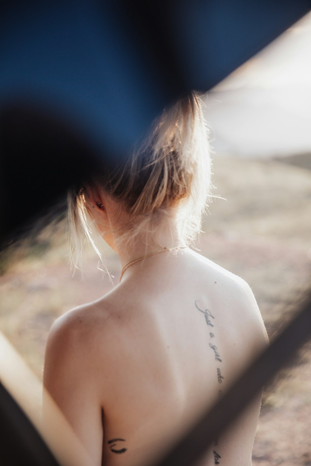 topless woman wearing black hat during daytime