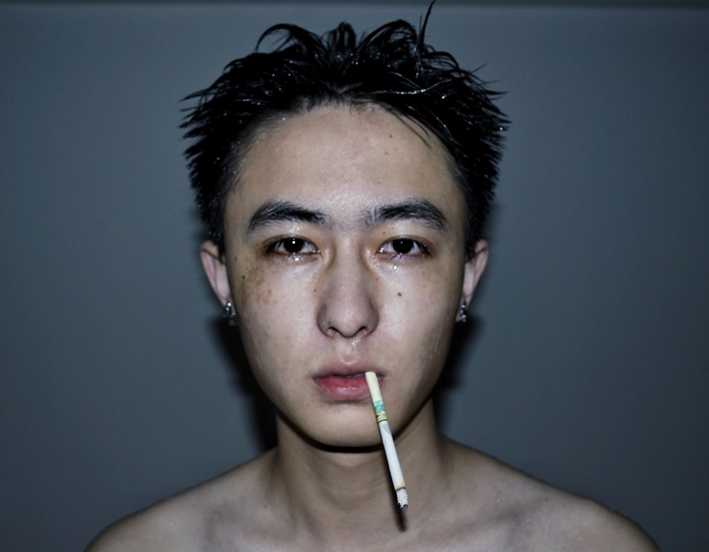 a man with a cigarette in his mouth