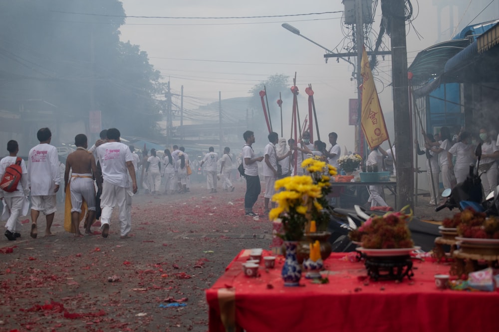 people in white uniform standing on red and yellow plastic container