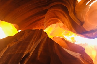 Sunlight casting warm hues on the red sandstone formations of Valley of Fire State Park during golden hour.