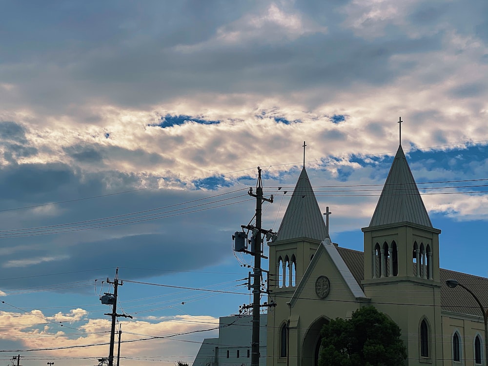 white and brown concrete building under white clouds and blue sky during daytime