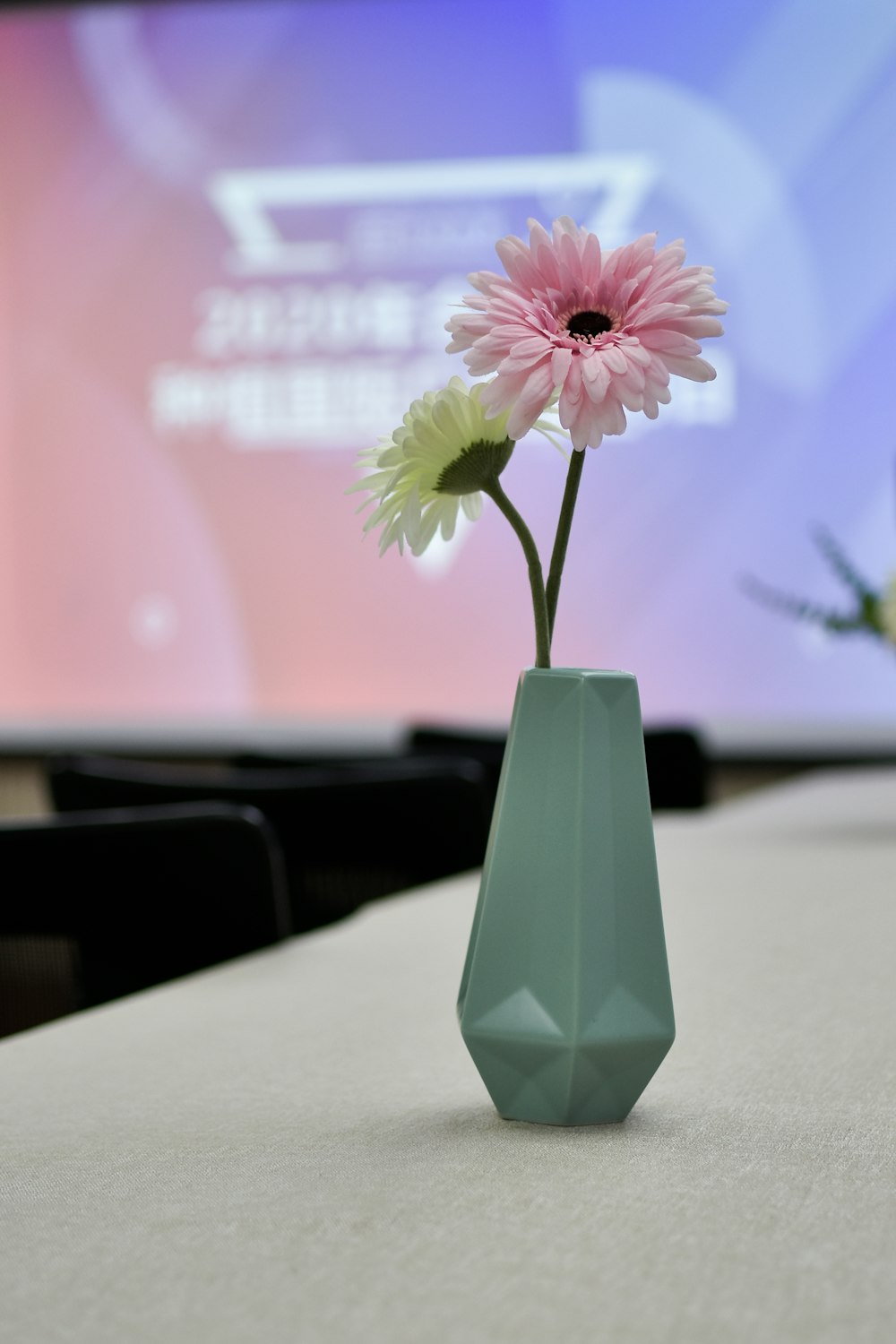 pink flower on green vase