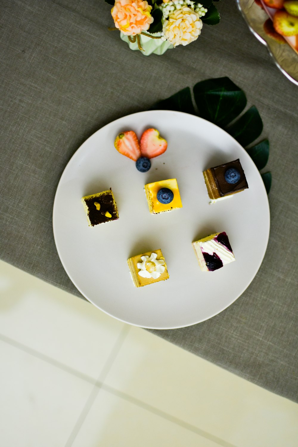 sliced fruits on white round plate