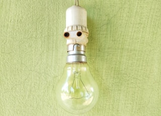 clear glass light bulb on green textile