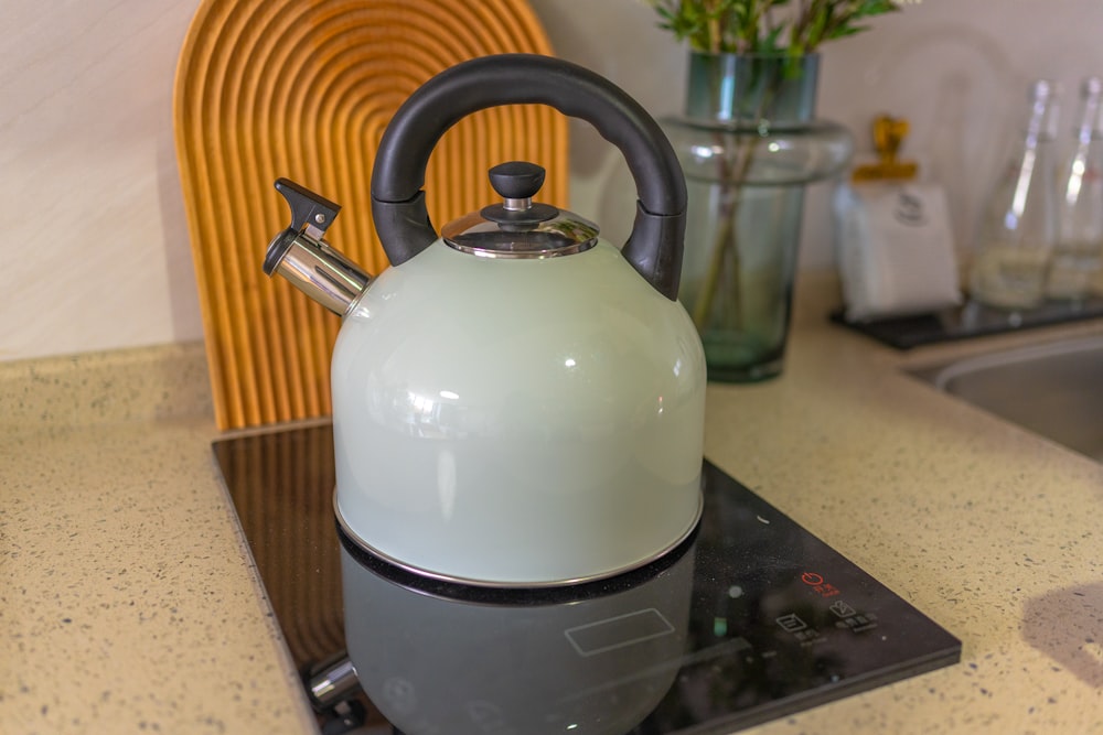 white and black kettle on stove