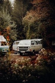 white van parked on green grass field during daytime