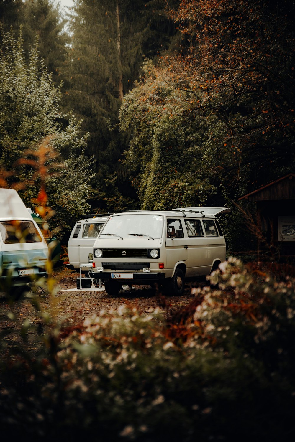 white van parked on green grass field during daytime